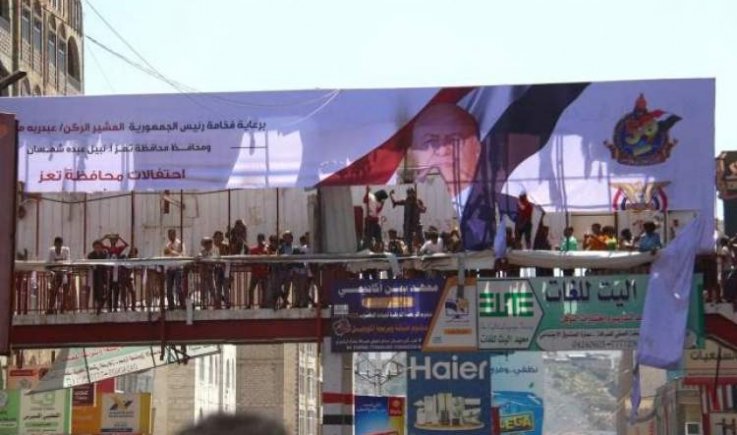 تمزيق صور " هادي " خلال انتفاضة شعبية في تعز